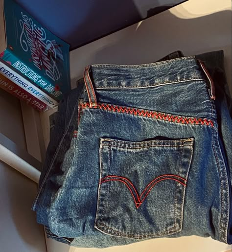 just an easy and quick way to give your jeans an amazing and unique look ! 💕 #embroidery #jeans #pants #clothes #levis #red #redyarn #pattern #redpattern #denim #books #nicolayoon #read #reading #book #everythingeverywhere #thesunisalsoastar #instructionsfordancing Levis Embroidery, Ripped Jean Embroidery, Embroidered Words On Jeans, Embroidery Patterns Jeans Pocket, Embroidered Denim Blue Jeans For Streetwear, Jean Embroidery, Levis Jean, Nicola Yoon, Jeans Embroidery