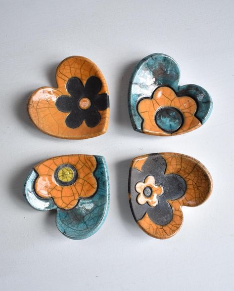 Some bright colours on a wet day in Fife. I’ve been pressing flower shapes into clay quite a bit recently. They’ve come out well on these little heart shaped trinket dishes. I think I need flowers in my life. It would be nice for spring to make an appearance, now please! 🌼☀️ . . . #springinscotland #scottishspring #trinketdishes #trinketdish #hearts #heartshapedgifts #heartart #rakufired #raku #handmadeinfife #scottishpottery #scottishpotters #daisy #artwithflowers #trinkets Clay Trinkets, Pottery Ring Dish, Pottery Ring, Flower Shapes, Pottery Crafts, Heart Art, Bright Colours, Be Nice, Ring Dish