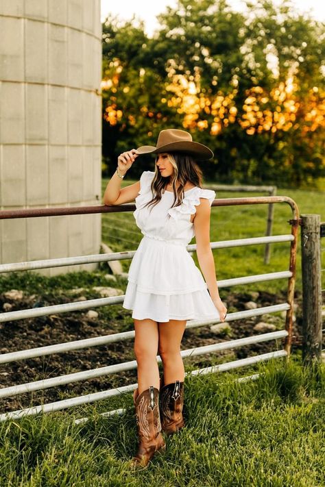 White Dress And White Boots, White Dresses Photoshoot, Grad Dress With Cowboy Boots, Cute Cowgirl Dress Outfits, Western Graduation Dresses, Senior Photo Country, Western White Dress With Boots, Cowboy Boots With A Dress, Pasture Picture Ideas