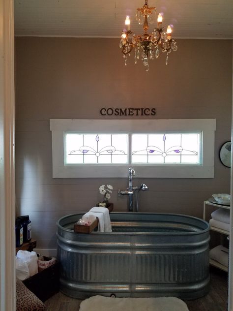 Galvanized horse trough tub and crystal chandelier = rustic chic bathroom Water Trough Bathtub Bathroom, Galvanized Bathtub Ideas, Galvanized Stock Tank Bathtub, Galvanized Tub Ideas Bathroom, Tin Ceiling Bathroom, Galvanized Tub Ideas, Water Trough Bathtub, Additions To House Ideas, Rustic Chic Bathroom