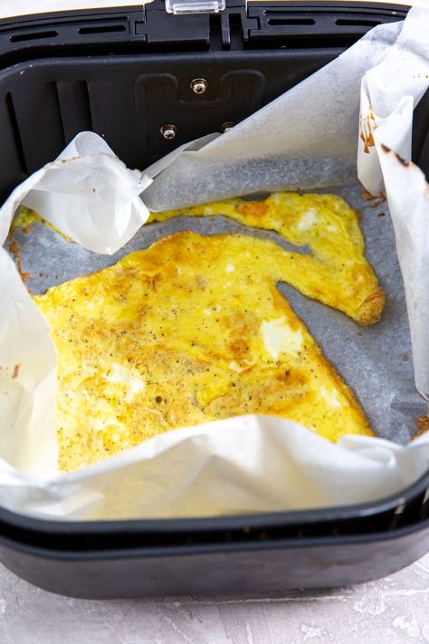 parchment paper in the air fryer with cooked scrambled eggs Eggs In Air Fryer Scrambled, Air Fryer Scrambled Eggs, Eggs In Air Fryer, Eggs In The Air Fryer, Large Air Fryer, Eggs In A Basket, Fat Soluble Vitamins, 7 Minutes, Low Carb Breakfast