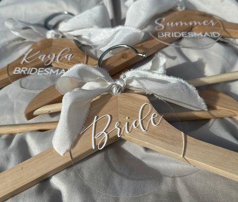 "Custom acrylic bridal hanger tags are the perfect addition to any bridal party's wardrobe. These tags are made from high-quality acrylic and are carefully crafted to be both durable and stylish. Each tag is designed to be completely customizable, allowing you to choose the text, font, and colour of your choice. These tags are not only practical for keeping your bridal party's outfits organized, but they also make a beautiful keepsake that can be cherished for years to come. Whether you're looking for a special gift for your bridesmaids or want to add a personal touch to your own bridal hanger, our custom acrylic bridal hanger tags are the perfect choice.   How To Order -Choose VINYL COLOUR -Choose BACKGROUND STYLE -Choose BACKGROUND COLOUR -Type NAME -Type TITLE (if no title wanted please Wedding Dress Hangers, Summer Bridesmaids, Bridesmaid Hangers, Bride Hanger, Bridal Hangers, Background Style, Bridal Party Outfit, Wedding Dress Hanger, Party Names