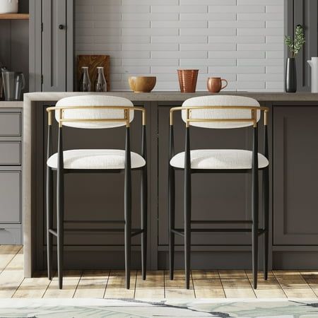 Practicality and sophisticated style collide to create our breathtaking barstool set. These two modern stools are incredibly captivating with their luxe, soft upholstery, toothpick designs, and eye-catching silhouettes. Durable black iron frames with gold accents give these chairs all the glamorous flair your space might be lacking, and open backrests complete the artistic look. Their striking design is sure to complete any carefully-curated space. Enjoy every part of your home and ensure that e