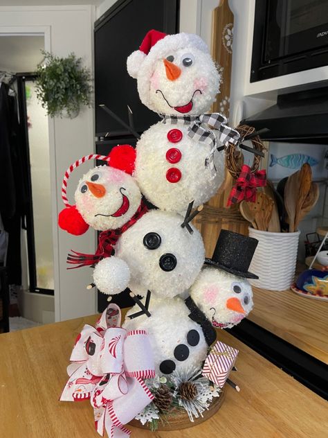 This adorable snowman tower is composed of styro foam balls, covered with faux snow. Each character is adorned with its own attire. A wired edge ribbon bow completes the look of this beautful hand made snowman table decoration. To see more creative projects I have done, please visit my you tube channel: Craft Central Designs. Snowman Contest Ideas, Snowman Building Contest, Styrofoam Snowman Crafts, Snowman Display Ideas, How To Make A Snowman, Snowman Diy Decorations, Creative Snowman Ideas, Snowman Display, Standing Snowman