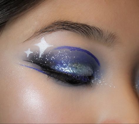 starry eyed makeup, midnights taylor swift inspired makeup, blue eyeshadow, creative eye makeup idea, glowy face makeup, blinding highlight, sparkly eye makeup, glittery makeup, juvia’s place duochrome liquid glitter eyeshadow, halsey about-face blue matte fluid eye paint, blue lip, lipstick, night makeup, makeup for eyes with epicanthic fold, asian eye makeup, fun face paint makeup, smoky blue makeup, brown eyes, highlighter makeup, full-face makeup, white dots, stars eye makeup, white eyeliner Midnights Inspired Makeup, Glowy Face Makeup, Midnights Taylor Swift Makeup, Eye Makeup White Eyeliner, Blue Makeup Brown Eyes, Space Themed Makeup, Stars Eye Makeup, Taylor Swift Inspired Makeup, Eye Makeup White