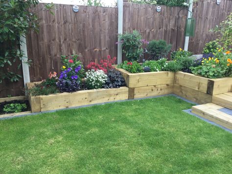 Raised sleeper beds Raised Flower Beds Sleepers, Raised Sleeper Beds, Sleeper Planter Ideas, Raised Flower Beds Along Fence, Sleeper Raised Beds, Patio Planting, Sleeper Beds, Easy Garden Ideas, Garden Wall Planter