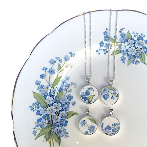 Give her the most thoughtful gift of a forget me not broken china pendant with a sterling silver chain that is simple, delicate, and meaningful. This dainty blue flower necklace is not only an elegant broken china jewelry piece, but carries a special significance. As the name indicates, the forget-me-not flower symbolizes love, fidelity, and remembrance, promising that you will never forget the recipient, an occasion, a person in your thoughts. It also symbolizes a connection that endures all ch Broken Pottery Jewelry, Broken China Crafts, Repurposed China, Blue Flower Necklace, China Crafts, Elegant Gift Wrapping, Porcelain Necklace, Flower Necklaces, Necklace Packaging