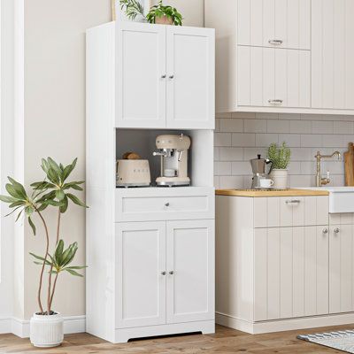 Upgrade your kitchen storage with this stylish and functional pantry. Made from engineered wood and finished in a fresh white hue, it features paneled doors that open to reveal three adjustable shelves for your culinary essentials. The lower drawer provides additional storage space for linens and silverware, while the microwave shelf offers a convenient spot for your handy kitchen appliance. With a weight capacity of 300 lbs. and a tip-over restraint device included, this pantry is designed to k Stand Alone Cabinet Kitchen, Kitchen Stand Alone Cabinet, Stand Alone Pantry Cabinet, Kitchen Storage Cabinets Freestanding, Functional Pantry, Small Kitchen Solutions, Food Pantry Cabinet, Standing Pantry, Kitchen Storage Furniture