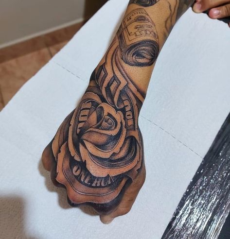 Cool Mexican Tattoos, Versace Hand Tattoo, Money Rose Hand Tattoo Men, Backhand Tattoos Men, Money Hand Tattoos For Guys, Fist Tattoo Ideas For Men, Money Rose Hand Tattoo, Hand Tattoos Cover Up, Hood Hand Tattoos