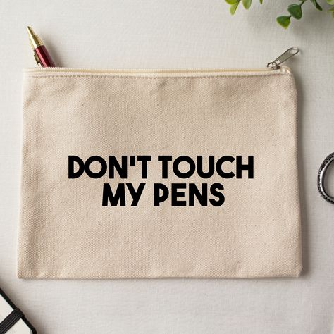 The DON'T TOUCH MY PENS canvas pouch is the perfect accessory for holding all of your essentials. It can be used for storing your makeup or your bits and bobs. This personalized pouch can be thrown in your bag or handbag. It is great for on the go and traveling. 100% cotton cream canvas zipper pouch 2 size options care instructions- spot clean or wash inside out and dry on low heat Canvas Zipper Pouch, Sarcastic Clothing, Personalized Pouch, Canvas Bag Design, Diy Tops, Diy Bags Patterns, Diy Tote Bag, Pen Pouch, Dont Touch