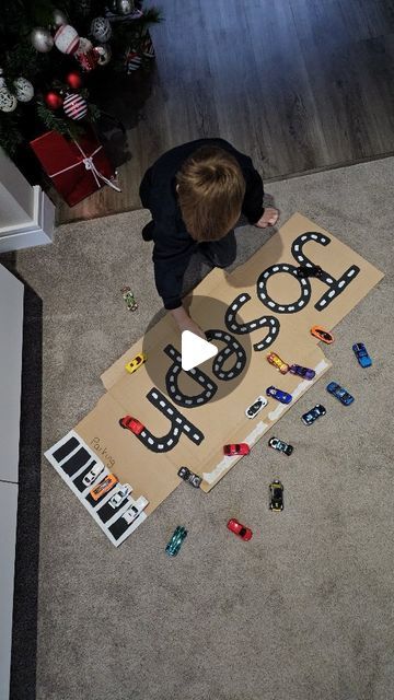 Katie-Rose Hardie on Instagram: "𝗡𝗮𝗺𝗲 𝗧𝗿𝗮𝗰𝗸 Joseph is getting really good at writing his name, but he always manages to do his 's' back to front. So I made him his name in car track form and he can practice driving over all the letters over and over again! I love finding ways to reuse cardboard packaging! #recycled_play #diyplayideas #diyplaythings #cardboardcrafts #letterformation #hotwheels #phonics #eyfsliteracyideas #eyfsteacher #eyfsteachersofinstagram #playathome #funbudgetplay #november_play" Car Tracks For Kids Diy, Car Track Cardboard, Diy Road Signs For Car Play, Tape Roads For Toy Cars, Cardboard Cars, Monster Truck Play, Colors Activities, Katie Rose, Cardboard Car