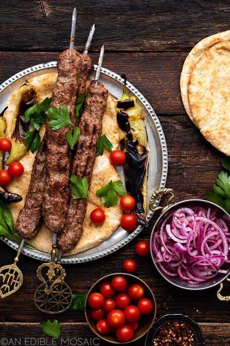 spread of turkish lamb kebabs with flatbread and vegetables Adana Kebab Recipe, Turkish Lamb, Adana Kebab, Sumac Onions, Kebab Meat, Turkish Kebab, Lamb Kebabs, Kebab Recipe, Grilled Peppers