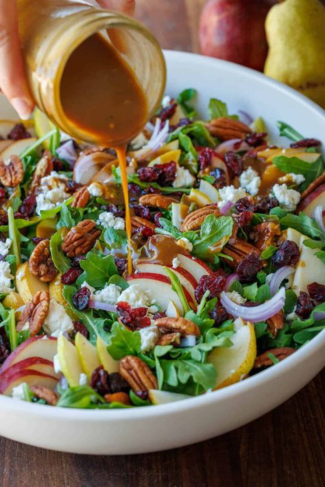 This Autumn Pear Salad recipe is simple but stunning. Combining sweet pears, fresh arugula, tangy Craisins, and crunchy nuts is the perfect blend of flavors and textures. Salad With Croutons Recipes, Pear Spinach Salad Recipes, Autumn Side Salad, Salad With Roasted Potatoes, Pear Salad With Balsamic Dressing, Salad With Mixed Greens, Lite Salad Recipes, Autumn Pear Salad, Best Cold Salads