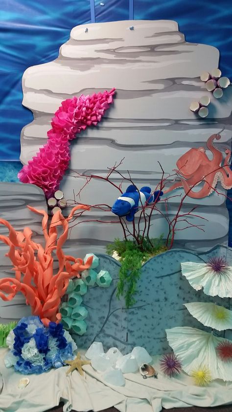 Coral reef scene of cardboard, paper, and pool noodles at BHCOC  Submerged VBS. Diy Paper Coral Reef, Coral Reef Stage Prop, Paper Coral Reef, Mermaid Props, Coral Reef Craft, Ocean Diorama, Submerged Vbs, Ocean Vbs, Ocean Commotion