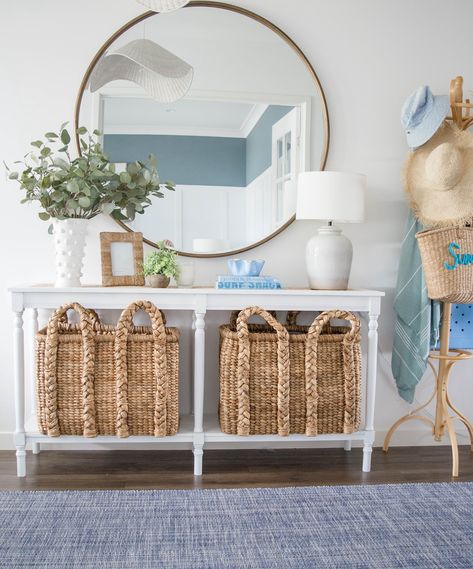 Spring brings with it a little refresh… There’s something about spring that calls for a little home update! 🌸 Our coastal-inspired entry got a fresh look. The woven baskets add warmth, while the larger round mirror reflects light, making the space feel bright and airy. 🧺💙 I love how the white console table creates a perfect balance between style and function—plenty of storage with a clean, crisp look. 🌊 A few subtle decor pieces, like the eucalyptus in a textured vase, bring the outdoors in ... Coastal Entryway Ideas Front Entry, Beachy Entryway, Coastal Entryway Ideas, Coastal Entryway, Textured Vase, White Console Table, Large Round Mirror, College House, Bathroom Cabinetry