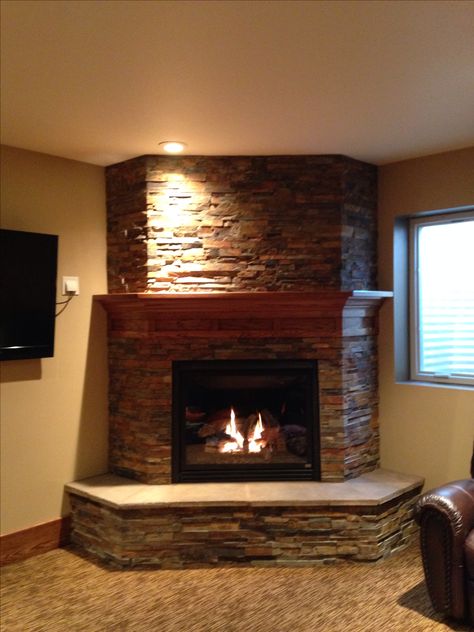 Basement fireplace- like the idea of the 3 sides to give it a bulkier look. Not a fan of the stone. Corner Fireplace Mantels, Corner Stone Fireplace, Corner Fireplace Decor, Corner Electric Fireplace, Corner Gas Fireplace, Fireplace Style, Basement Fireplace, Brick Fireplace Makeover, Living Room Corner