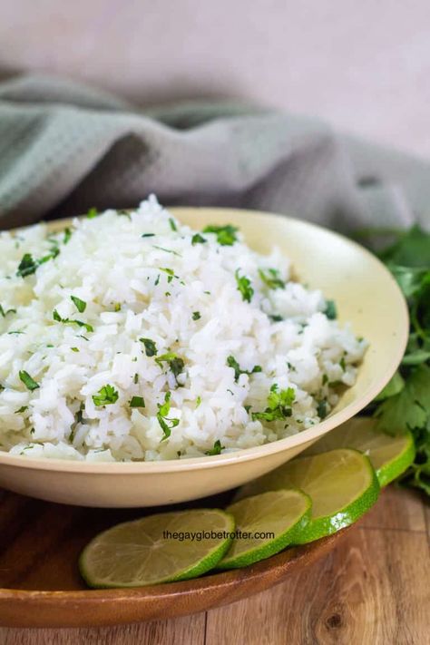 This easy cilantro lime rice recipe will elevate any meal. With just a few ingredients, cilantro lime rice is the perfect, fresh, and delicious side dish! #gayglobetrotter #cilantrolimerice #rice #lime #cilantro #sidedish Chipotle Cilantro Lime Rice, Cilantro Lime Rice Recipe, Lime Rice Recipes, Cilantro Rice, Lemon Rice, Lime Rice, Cilantro Lime Chicken, Cilantro Lime Rice, Lime Chicken