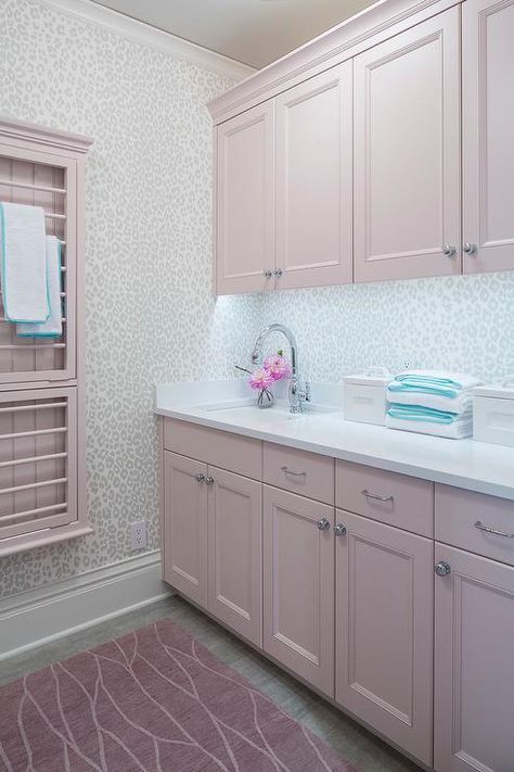 Pink laundry room features pink cabinets paired with white quartz countertop and a leopard print wallpaper as backsplash, Thibaut Fabric Animal Print Wallpaper. Pink Laundry Room, Pink Laundry, Pink Laundry Rooms, Pink Cabinets, Leopard Print Wallpaper, White Laundry Rooms, Chic Bedrooms, Classic White Kitchen, White Laundry