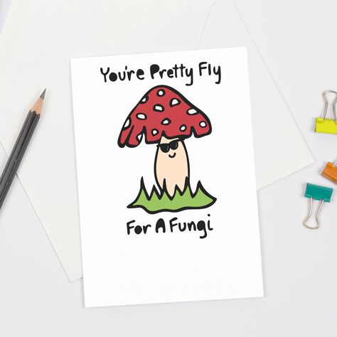 This cute mushroom-themed greeting card is perfect for any guy! The front of this cute and funny card features a red and white fly agaric toadstool wearing sunglasses with hand lettered text that says "You're Pretty Fly For A Fungi" (a fun pun on the song lyrics from "Pretty Fly (For A White Guy)" by 90s band The Offspring). Sustainably sourced card stock – proudly printed in the USA! Comes with coordinating white envelope. Each card is approximately 4 1/16" x 5 13/16" in size (when folded). Env Funny Greeting Cards Hilarious, Punny Cards For Friends, Cute Pun Cards, Mushroom Puns, Thanksgiving Puns, Postcards Inspiration, Greeting Card Ideas, Pun Cards, Cheesy Puns