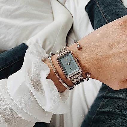 The 24mm Skylar brings back a vintage shape with a modern edge. This model wears a polished silver and blue colorway with a 5-link band. Mvmt Watches, Classic Jewelry Pieces, Engineered Quartz, Blue Watches, Womens Watches Luxury, Stylish Watches, Classic Jewelry, Square Watch, Handbags Michael Kors