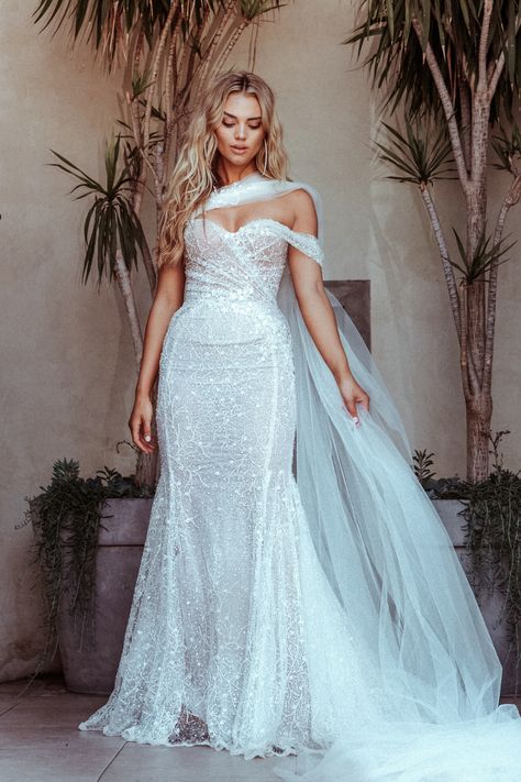 For a whimsical and bold statement our Galia Lahav couture #Simone mermaid wedding dress is beautifully embroidered with scattered pearls and shimmery sequins and has added romance with a sheer cape that attaches to the sweetheart neckline. Shimmery Wedding Dress, Galia Lahav Bridal, Elegant Bridal Dress, Sheer Cape, 2024 Bride, Wedding Swag, Fairy Wedding Dress, Wedding Dress Cake, Galia Lahav