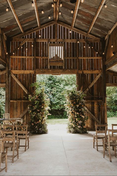 Rustic Nancarrow Farm wedding venue with two flowers columns for altar decoration and wooden chairs Nancarrow Farm, Farm Wedding Decor, Wedding Venue Barn, Rich Wedding, Shed Wedding, Barn Wedding Ideas, Chairs Wedding, Farming Ideas, Farm Cafe