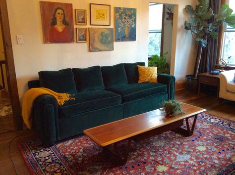 Vintage eclectic living room with green velvet sofa, mcm coffee table, wool rug. Green Couch Living Room Coffee Tables, Green Couch Persian Rug, Black Mcm Sofa, Dark Green Velvet Sofa Living Room Ideas, Green Couch Red Rug Living Room, Green Sofa Red Rug, Red Rug Green Couch, Green Couch Red Rug, Green Velvet Sofa Color Combinations