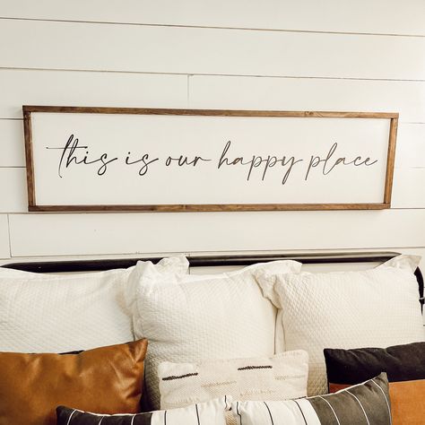 "this is our happy place  Free shipping in the continental U.S. White background with black lettering and your choice of frame color.  (to change the background or lettering color, put a note in the comment section at checkout) Available in 6 sizes: Shelf size - 7.5\" x 25.5\" x 1.5\" Twin size - 10.5\" x 37.5\" x 1.5\" Queen size - 13.5\" x 49.5\" x 1.5\" Queen Lg - 17.5\" x 49.5\" x 1.5\" King size - 13.5\" x 66\" x 1.5\" King Lg - 17.5\" x 61.5\" x 1.5\" (give or take half an inch on all dimensions) Each sign has two claw hooks for easy hanging.  I will do my absolute best to get your sign shipped to you as soon as possible! These signs need lots of love from me before they can be loved by you! Please check my shop homepage for up to date processing times.   Please double check your shi Sign Above Bed Master Bedrooms, Signs Above Bed Master Bedrooms, This Is Our Happy Place, Signs Over Bed Master Bedrooms Behind, Above The Bed Wall Decor, This Is Our Happy Place Sign, Bedroom Signs Above Bed Single Person, Wood Sign Above Bed Master Bedrooms, Romantic Sign Above Bed