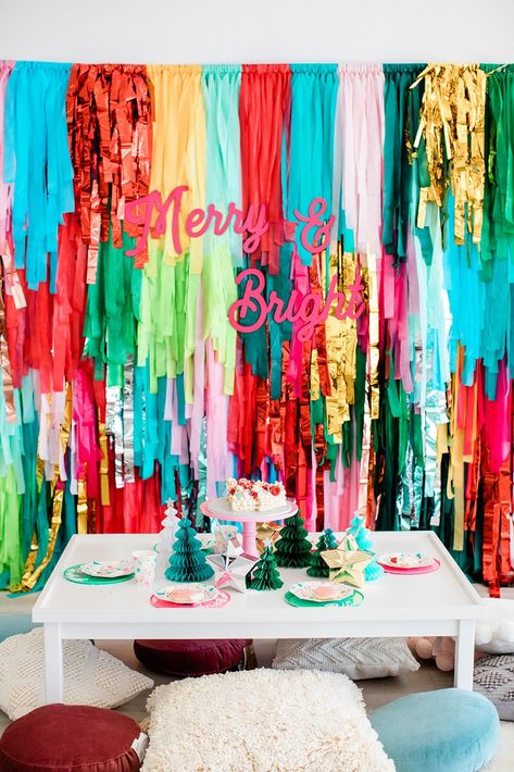 Merry And Bright Party Theme, Christmas Streamer Backdrop, Christmas Light Parade Ideas, Feliz Navidad Party Decorations, Santa Themed Birthday Party, Cheer Christmas Party Ideas, Bright Color Christmas Decor, Christmas Fringe Backdrop, Feliz Navidad Christmas Party