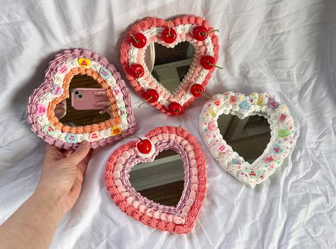 Have your cake & decorate your home too! These heart cake mirrors add sass and flair to any space. Available in a variety of styles with details such as faux cherries, faux candies, sprinkles, imitation frosting, and pearls. Each mirror is hand decorated. Has a picture frame style back to prop up or hardware to hang on the wall, like you would a picture frame. Small variations (example: different color placement of candy sprinkles) can occur from mirror to mirror and should be expected. Listing is per one mirror. Small Mirror Decorating Ideas, Cake Mirror Diy, Small Mirror Decor, Decorated Picture Frames, Decorate Picture Frames, Decorate Mirror, Kawaii Mirror, Cute Mirrors, Decorated Mirrors