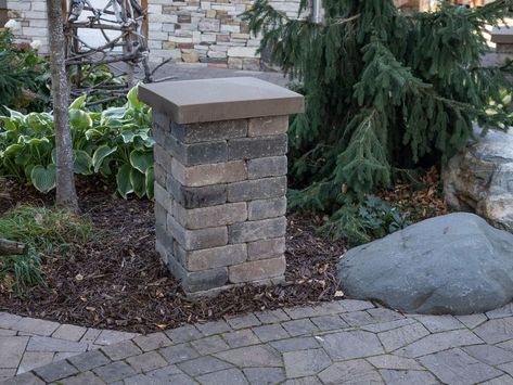 How to Install a Patio Landscape Block Pillar : Landscape block pillars add so much to your outdoor living space. They can help to define the space by giving it definition. The create dimension by being a vertical element in the landscape. With the addition of landscape lighting your usefulness of outdoor space can be extended into the evening. The great part about using concrete landscape retaining wall block to build a pillar is that it's not really all the difficult to add such a be… Pillar Design Exterior Entrance, Landscape Retaining Wall, Paver Ideas, Brick Pillars, Landscaping Blocks, Retaining Wall Block, Brick Ideas, Outdoor Columns, Patio Paving