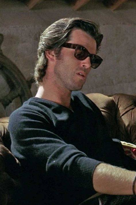 Taffin looks to wear Persol Sunglasses 2803-S when he delivers the famous ‘maybe you shouldn’t be living here’ line. Jfk Sunglasses, James Dean Sunglasses, Persol Steve Mcqueen Sunglasses, James Bond Style, Persol Glasses, Persol Sunglasses, Pierce Brosnan, James Bond, Falling In Love