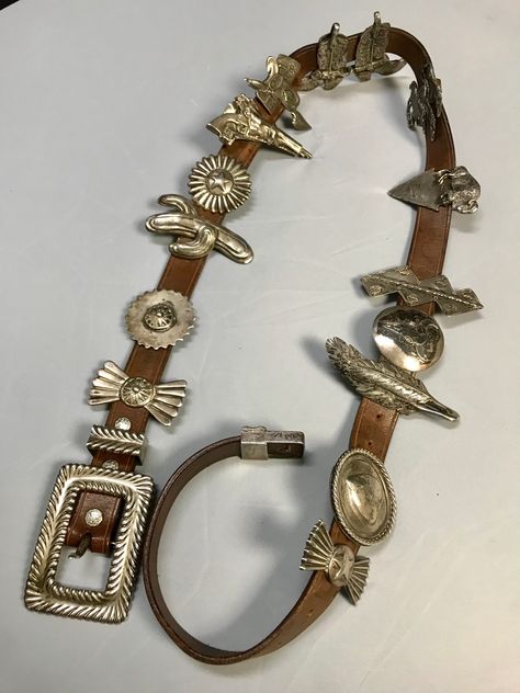 Arnold Goldstein Sterling Silver Concho Brown Belt Weight: 958 Grams, Lbs 2.1 Approximate Measurements: Belt Length: 47" Belt Width: 1" Charms from 2" to 3.5" Arnold Goldstein sterling silver concho brown belt 14 charms. Arnold Goldstein’s passion for Western and American Indian art began in his teens. At the age of 20, he was earning a living as a professional sculptor. Goldstein’s range as an artist, sculptor & designer is impressive. His western sculptures are reminiscent of Remington’s a Vintage Western Jewelry, Western Style Jewelry, Indian Inspired Jewelry, Belts Aesthetic, Western Inspiration, Western Sculpture, Western Womens Fashion, Work Belt, Looks Country