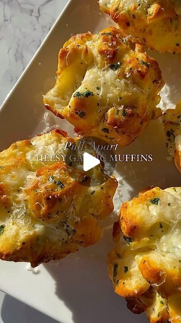 Eating Micheline🍋🥐🌮 on Instagram: "cheesy garlic bread muffins I pull-apart style with garlic butter, mozzarella & parsley. Perfect little appetizer or snack🧀😋

Recipe (makes 6 large muffins)
•dice one can of homestyle biscuit dough into
small pieces
•add to a bowl with 1/4 cup chopped parsley
•add 3tbsp melted butter with 1tbsp minced garlic
•dice 4-5 mozzarella cheese sticks & add to bowl
•gently mix it all together
•form into balls and place in cupcake pan
•bake at 375 for 15 minutes

made by shewillevolve💗💗

#cheesybread #garlicbread #easyrecipes
#snackideas #easysnack #appetizers
#appetizerideas #quickrecipes #biscuits
#recipeshare #recipeoftheday" Cheesy Garlic Bread Muffins, Garlic Bread Muffins, Comfort Snacks, Large Muffins, Hostess Snacks, Mozzarella Cheese Sticks, Bread Muffins, Cheesy Garlic Bread, Biscuit Dough