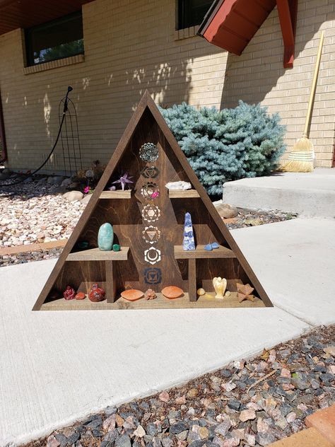 You are looking at a beautifully hand crafted crystal chakra shelf. Chakras are the circular vortexes of energy that are placed in seven different points on the spinal column, and all the seven chakras are connected to the various organs and glands within the body. These chakras are responsible for disturbing the life energy, which is also known as Qi or Praana. This shelf is made out of Popular wood. Popular is known for spirituality, blocking unwanted forces, divination, change, rebirth, summo Shelf Designs For Hall, Crystal Collection Display, Chakra Wall Art, Shelf Measurements, Geometric Shelf, Chakra Gemstones, Spiritual Altar, Ooga Booga, Spinal Column