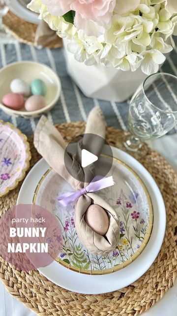 Becca Mansfield | Party Planner 🎉 on Instagram: "These are the little traditions that your kids or dinner guests will remember — the extra touches that make the holiday magic. This napkin fold is SO easy and uses the supplies you already have. Try this for your Easter table and let me know how it goes! 🥰 How to fold a bunny ear napkin: 🐰 1. Unfold a square napkin and lay it down flat 2. Fold one corner up to the opposite corner 3. Fold up from the bottom in ≈1.5” rolling folds until you reach the top 4. Place an egg in the middle and finish with a ribbon bow or napkin ring That’s it! So simple, but so fun for your Easter table setting. Wishing you a beautiful holiday, 💗B . . Wildflower plates from @orientaltrading Napkins and speckled eggs from @tjmaxx Woven placemats from @h Easter Dinner Party Table Settings, Bunny Ear Napkin Fold, Easter Napkins Folding, Easter Napkin Folding Ideas, Bunny Napkins Fold Tutorials, How To Fold A Napkin With A Ring, How To Fold Napkins With Ring, Easter Dinner Table Setting, Napkin Ring Folding