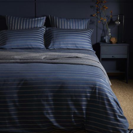 This is one of our favourite colour combinations, mixing dark blue and natural hues with our stylish Breton Stripe design.  Part of our luxury bedding, this blue striped duvet cover, is woven from 100% cotton (50% Egyptian cotton) with a 260 thread count. The super soft sateen finish feels smooth to the touch, making bedtimes even better. The design is fully reversible, so you can mix up how you want your bed to look as often as you fancy.  A perfect match for our Twill Midnight Blue bed linen. Popular Blue Paint Colors, Posh Pennies, Blue Bedroom Paint, Blue Bed Sheets, Blue Bedrooms, Blue Linen Bedding, Blue Duvet, Striped Duvet Covers, Luxury Duvet Covers