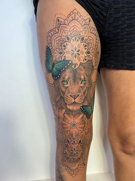 Female Lion Mandala Tattoo Lion Tatoos Woman Thigh, Lioness Tattoo For Women Leg, Butterfly And Lion Tattoo, Lion With Mandala Tattoo Design, Lion Knee Tattoo, Lion Leg Tattoo Female, Lion Tattoo Thigh, Female Knee Tattoos, Half Leg Sleeves For Females