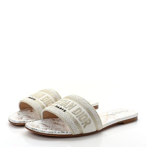 These are an authentic pair of CHRISTIAN DIOR Canvas Lurex Jardin d'Hiver Embroidered Dway Flat Slide Sandals 38.5 in White and Palladium. These gorgeous sandals are crafted of embroidered cotton canvas in white and gold and feature a prominent "Christian Dior Paris" Dior logo on the strap. They have brown leather outsoles, with a comfortable 0.25-inch heel. White Dior Sandals, Dior Flat Sandals, Christian Dior Sandals, Dior Flats, Christian Dior Shoes, Christian Dior Paris, Dior Paris, Dior Sandals, Dior Logo