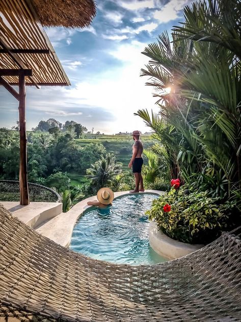 man and woman at pool overlooking rice terraces River House Bali, Bali Jungle Resort, Bali Treehouse Resort, Pyramid House, Babymoon Destinations, Bali Bucket List, Mount Batur Bali, Bamboo Indah Bali, Aesthetic Interior Design