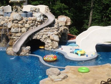 Here we see a water slide placed along a castle-esque stone structure in this water park area. Water slides are the quintessential feature of a water park. They can provide hours of fun and are by far the best way to get into the pool. Water Park Ideas, Backyard Water Parks, Lazy River Pool, Backyard Pool Design, Interior Design Blogs, Space Kids, Playroom Design, Design Blogs, Dream Pools