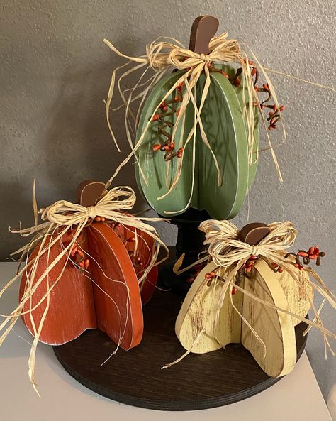 Hand made 3D pumpkin trio. Each one is painted to look aged, sanded and adorned with pipberry trellis and a raffia bow. Each pumpkin is finished on both sides so they can be displayed in the middle of a table.  They do come apart for easy storing.  Will be shipped apart for easy shipping. Small Hay Bale Fall Decor, Wooden Pumpkin Crafts, Hay Bale Fall Decor, Fall Primitives, Wire Pumpkin, Green Pumpkins, 3d Pumpkin, Fall Wood Crafts, Fall Pumpkin Decor