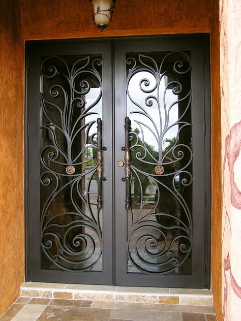 Customized ironwork with intricate designs or patterns can make a striking and unique statement Hunter Green Christmas Decor, Black And Green Christmas Decor, Red Ribbon Week Ideas, Black And Green Christmas, Hunter Green Christmas, Wrought Iron Glass Door, Christmas Decor Black, Wrought Iron Security Doors, Green Christmas Decor