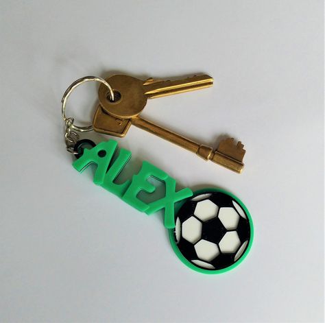 These 3D printed personalised football themed keyrings make a great addition to keys, bookbags, rucksacks etc. This listing is for 5 or more keyrings, please see our single listing for single keyrings. We can personalise these keyrings with any name, and they measure 4cm wide at the football, 2cm for the writing.  To Order: Please let us know in the 'note to seller' option in your basket which name(s) and colour(s) you would like which on ordering. E.G Mia -Royal Blue        Thomas - Fluorescent Kids Football Party, Kids Football Parties, Football Favors, Keychain Kids, Football Keychain, Diy Keyring, Soccer Kids, Used Solar Panels, Clay Keychain