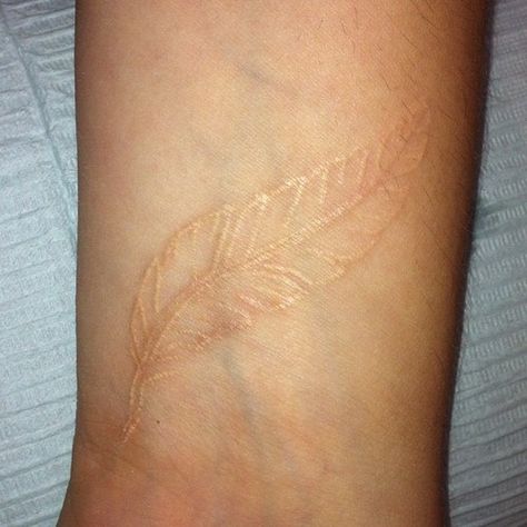 White Feather Tattoos, Gold Tattoo Ink, Brown Tattoo Ink, Tattoo Feather, Elephant Tattoo Design, Gold Tattoo, Metal Tattoo, Healing Tattoo, Feather Tattoo