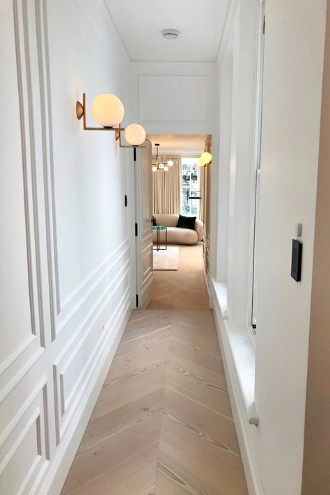 A traditional yet contemporary feel to this newly refurbished property. White panelled walls and light oak flooring complete the hallway lleading down to the guest bedroom.  #whitewalls #panelling #interiorinspo #hallway Panelled Hallway, Light Oak Flooring, Hallway Panelling, Panelled Walls, Light Oak Floors, Living Room Panelling, White Hallway, Hallway Wall Lights, Hallway Inspiration