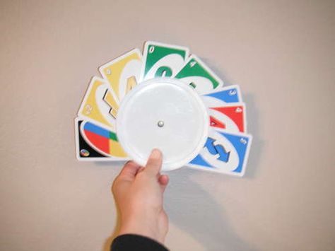 Playing Card Holder for Little Hands: I use a drop of hot glue to hold the two lids together. Nothing on which to stick little fingers.  If you have a bunch of lids , you can also type game directions on a cd label and stick to holder.  Put holder and cards in a baggie and set in your games center. Game ideas to follow. Diy Card Holder For Kids, Diy Bracelet Holder, Card Holder Diy, Diy Playing Cards, Old Maid, Play Card, Brass Fasteners, Playing Card Holder, Play Cards