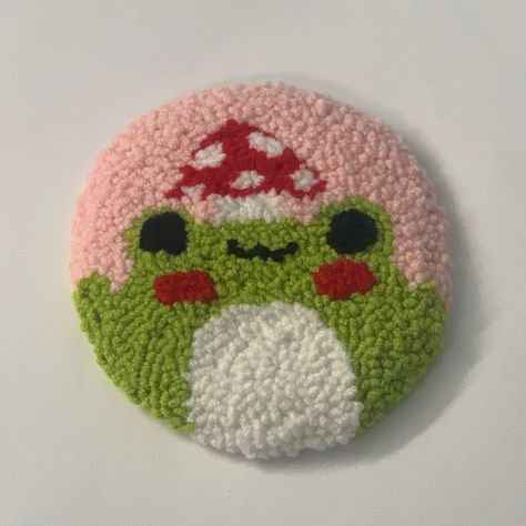 Punch needle coaster, cute animated frog with mushroom on head. Frog Punch Needle, Frog Coaster, Punch Needling, Frog Mushroom, Mug Coaster, Punch Needle Patterns, Needle Crafts, Green Frog, Weaving Projects