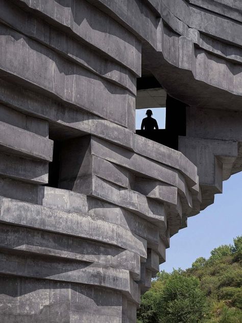 Nestled in a mountainous valley two hours away by car from the center of Beijing, The Chapel of Sound is a monolithic open-air concert hall with views to the ruins of the Ming Dynasty-era Great Wall. Designed by Beijing-based architecture office, OPEN, to look as a mysterious boulder that had gently fallen into place, the building is built entirely from concrete that is enriched with an aggregate of local mineral-rich rocks, and encompasses a semi-outdoor amphitheater, outdoor stage, viewing pla Layered Architecture, Shell Structure, Sound Picture, Open Architecture, Outdoor Stage, Concrete Building, Outdoor Concert, Concrete Structure, Architecture Office