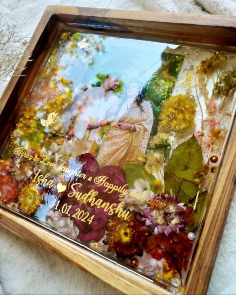 Looking for special gifts for newly weds?? You are in the right place ✨ My dad being a fan of trending teakwood frames asked me , could u create a photo frame as a wedding gift for a couple. And here it is! Crafted this beautiful vibrant yet elegant looking frame for a beautiful couple. And he absolutely loved the frame ❤️ Isn't it a special feeling when our family loves our work & supports us becoming a client ? 💞 Dm to order yours! #weddingframes #weddinginspiration #resinteakwoodframe ... Resin Art For Anniversary, Resin Art Frames For Couple, Gifts For Newly Weds, Photo Frame Wedding, Resin Photo Frame, Best Gifts For Couples, Wedding Frame Gift, Marriage Anniversary Gifts, Calendar Background